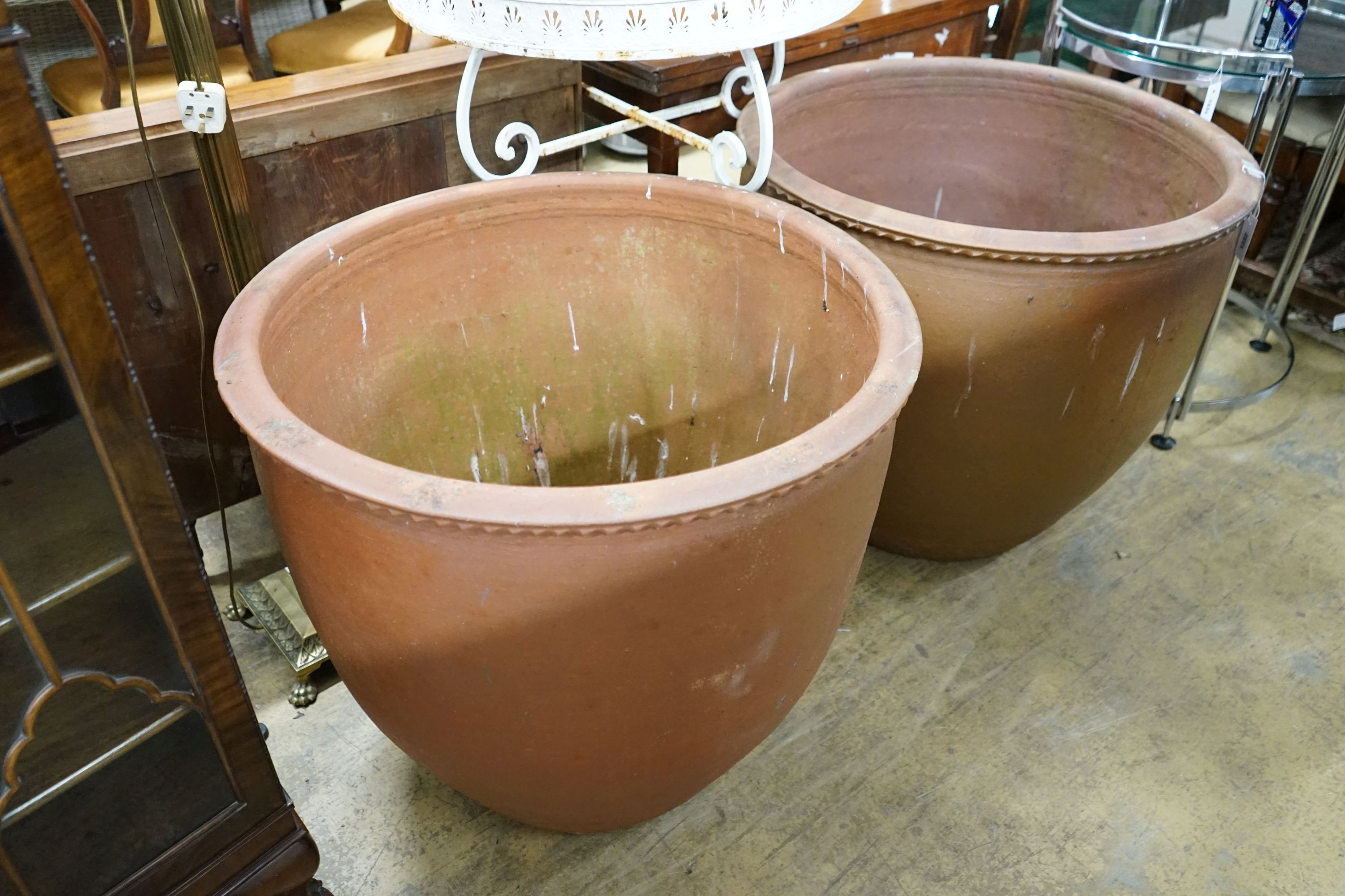 A pair of large circular terracotta planters, diameter 79cm, height 69cm